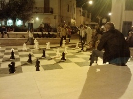 A game of chess being played in the square.